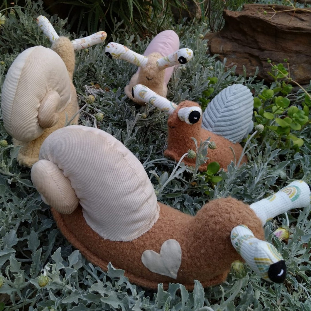 Four plushy snails with curly shells and pokey eyes