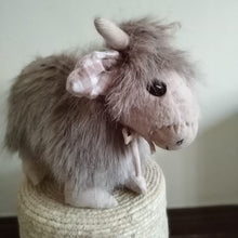 Load image into Gallery viewer, Light coloured highland cow plushy with check ears, cute smile, bow and adorable horns
