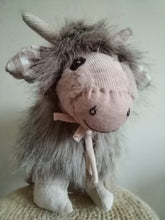 Load image into Gallery viewer, Light coloured highland cow plushy with check ears, cute smile, bow and adorable horns
