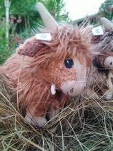 Load image into Gallery viewer, Red-brown coloured highland cow plushy with check ears, cute smile, bow and adorable horns
